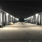 industrial buildings Wall Pack Lighting  open garage doors at night.